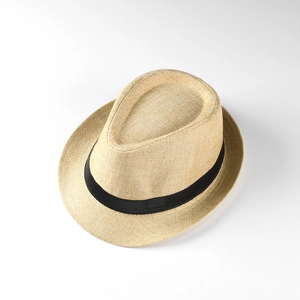 Close-up of woven linen sun hat with black satin ribbon trim for summer vacations