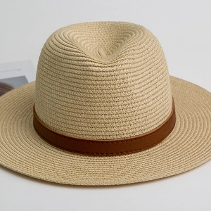 Close-up of fedora straw hat weave texture with dark brown faux leather decorative band