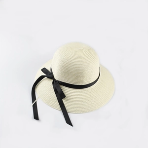 Beige straw sun hat with black bow ribbon and wide brim for summer beach style