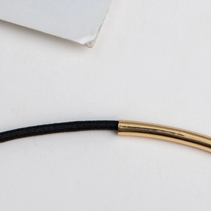 Minimalist black cord hat decoration band with polished gold-plated metal tube end