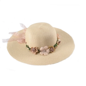 Foldable beige straw sun hat with decorative silk flowers and sheer pink bow for beach wear