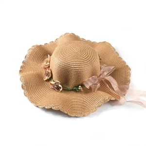 Detailed close-up of woven paper straw texture with silk rose and organza ribbon