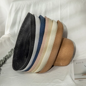 Stacked sun hats in multiple colors featuring premium natural woven straw textures