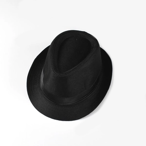 Detailed macro view of black linen jazz hat showing breathable woven texture and satin ribbon