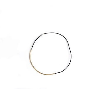Minimalist black cord necklace featuring a curved gold-plated metal tube center