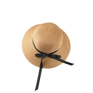 Classic woven straw sun hat for women featuring a black ribbon bow on white background