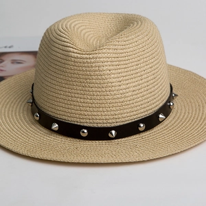 Straw Panama hat in khaki with black band featuring silver punk spikes and metal studs