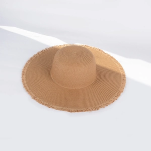 Women summer straw sun hat with large frayed edges and foldable woven design for beach