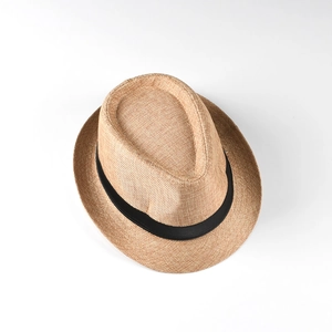 Close-up of lightweight straw fedora hat featuring woven texture and black ribbon band
