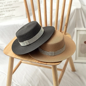 Detail of summer boater hats in black and natural brown with sparkling rhinestone bands