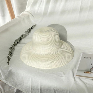 Chic wide-brim straw hat in ivory white for sun protection and summer travel