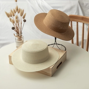 Flat top wide brim straw hats in cream and camel colors with fine woven texture