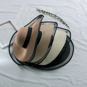 Detail view of four foldable mesh sun hats in khaki, cream, and black for summer travel