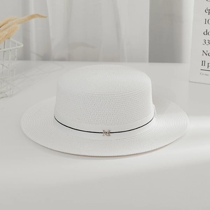 Macro shot of white boater hat texture with elegant ribbon and gold M letter charm