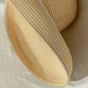 Close-up detail of high-quality hand-woven straw hat showing breathable natural fiber texture