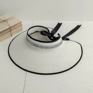 Elegant white straw sun hat with black bow and silver sequins for summer travel