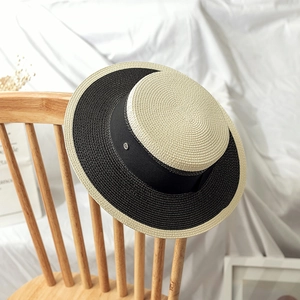 Chic two-tone flat top straw boater hat with black ribbon and metallic logo detail