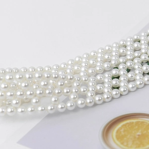Handmade woven pearl hat band accessory featuring multi-row white pearls on white base