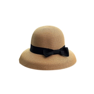 Women's foldable straw sun hat with black ribbon bow for outdoor travel protection