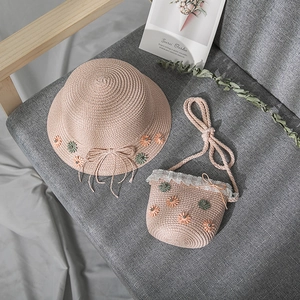 Detail of pink straw hat and crossbody bag set with lace and 3D daisy flower accents