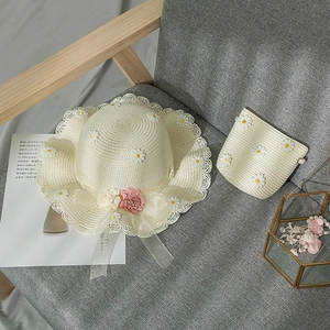 Matching set of daisy-themed straw sun hat and mini shoulder bag for girls and women