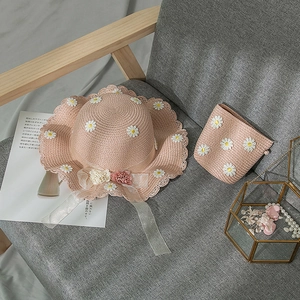 Pink wide brim straw hat and matching bucket bag set with white daisy lace details