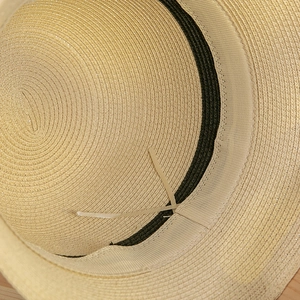 Close-up of the adjustable inner band and woven straw texture of this sun hat
