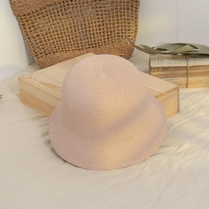 Detail of minimalist woven straw bucket hat with fine texture in natural beige
