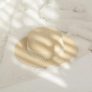 Elegant wide brim flat top straw sun hat with decorative pearl band for women