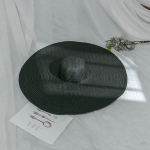Summer wide brim black straw hat for beach sun protection with foldable woven texture