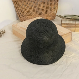 Detailed macro view of the woven black straw bucket hat showing intricate texture and weave