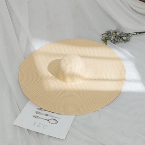Artistic detail of summer straw hat with elegant light and shadow on the wide brim
