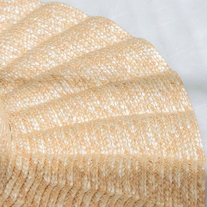 Close-up detail of woven straw sun hat brim showing natural fiber texture and pattern