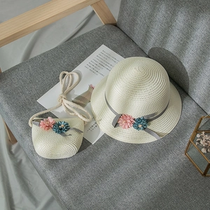 Girl's woven sun straw hat and matching bag with floral accents and ribbon detail