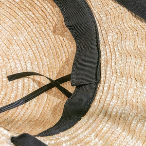 Detail of adjustable inner sweatband and straw weaving texture on sun hat