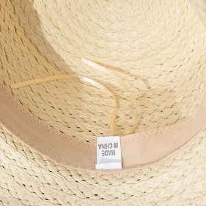 Detailed macro view of straw hat inner lining with adjustable drawstrings and sweatband