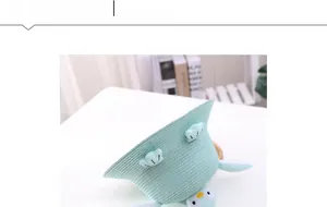 Close-up of mint green straw sun hat with white clouds and cute penguin detail