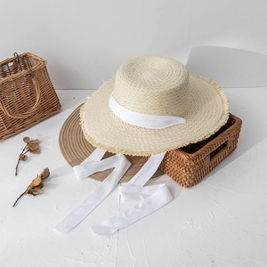 Summer flat top straw hat with frayed edges and long white ribbon tie for women