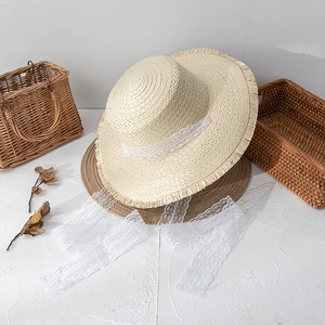 Women's straw hat with lace ribbon and raw edges in beige and brown colors