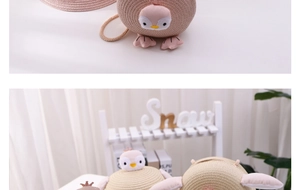 Close-up of cute straw crossbody bags for kids featuring animal penguin designs in beige