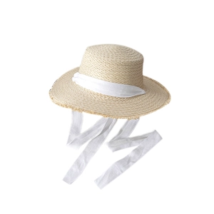 Women's wide brim straw sun hat with bow tie ribbons and frayed edges on white background