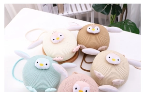 Detailed view of assorted round woven penguin bags for children in multiple colors