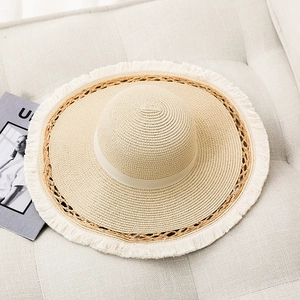 Flat top straw sun hat with frayed fringe brim and lace cutout pattern detail