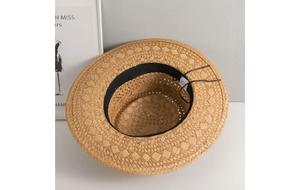 Detail of hand-woven straw Panama hat showing inner sweatband and material texture