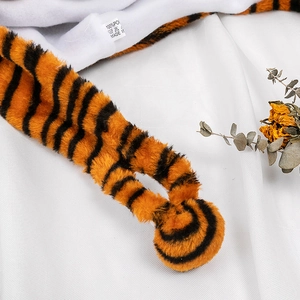 Close-up of tiger stripe faux fur plush hat with soft fleece lining and care label