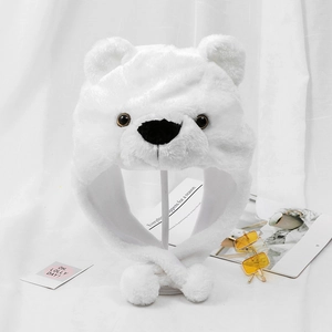 Detailed view of the soft white plush fabric and fluffy pom-pom on the bear earflap hat