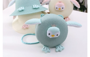 Detailed view of woven penguin bags and sun hats set for children in mint and yellow