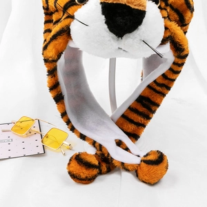 Detail of plush tiger hat with scarf showing soft faux fur texture and black stripes
