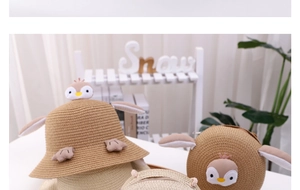 Detail of children's penguin straw sun hat and matching round bag with cute 3D cartoon decor
