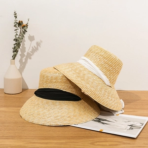 Handwoven straw sun hat with elegant ribbons for summer beach travel and outdoor leisure